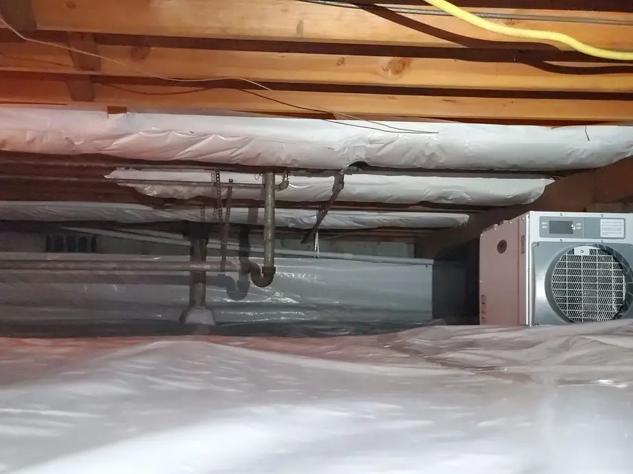 Finished RGS crawl space with new vapor barrier laid across the ground and insulated ductwork overhead